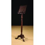 An Early 18th Century Oak Lectern with a shaped book rest on a tall baluster turned column with