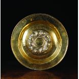 A 16th Century Brass Nuremberg Alms Dish having a raised boss of gadrooning around a central