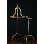 A 19th Century Wrought Iron Larkspit and a Rushlight with candle-socket on tripod base.