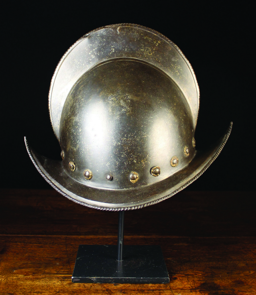 A 16th CenturySpanish Conquistador Morion Helmet; the comb and upswept brim edged in ropetwist,