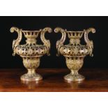 A Pair of Unusual Late 19th Century Carved & fretted Gilt-wood Urns with scrolling foliate handles,