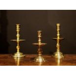 Three Dutch Brass Heemskirk Candlesticks; one 17th century, 7½ ins (19 cms) high,