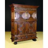 A Mid 17th Century Flemish Carved Oak Four-door Cupboard or ‘Beeldenkast’ with an upper and lower