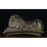 A 17th/Early 18th Century Carved Recumbent Lion resting over an arch,