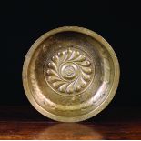 A 16th Century Nuremberg Brass Repoussé Alms Dish having a gadrooned boss centred by a rosette