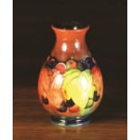 A Small Moorcroft flambé glazed Vase decorated with leaf and fruit design, Circa 1920's,