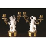 A Pair of 19th Century Sèvres Style Bisque Figural Candelabra modelled in the form of the infant