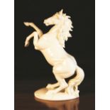 A Nymphenburg White Glazed Model of a Prancing Horse, impressed model number 733 8 to base,