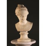 A Victorian Carved Carrara Marble Bust of a Classical Lady on a turned scotia base,