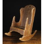 A 19th Century Scumbled Pine Child's Rocking Chair of boarded construction.