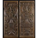 A Pair of Renaissance Style Carved Oak Panels depicting urns flanked by zoomorphic dolphins;