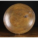 A Large 18th Century Turned Treen Charger, 19 ins (48 cms) in diameter.