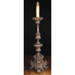 A Bronze Patinated Pricket Stick Lamp composed of embossed sheet metal and having an ornate knopped