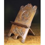 A Folding Walnut Book Rest constructed from one piece of timber and carved with a Romayne portrait