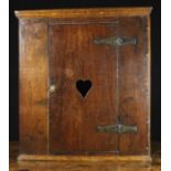 An 18th Century Boarded Oak Corner Cupboard.