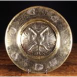 A 16th Century Repoussé Brass Alms Dish.