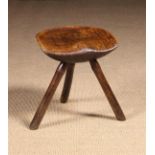 A Rustic Saddle Seat Stool on splayed stick legs 16½ ins (42 cms) high,