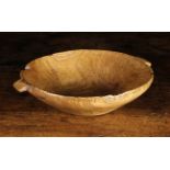 A Small Dug-out Elm Bowl with lug handles, 2½ ins (6 cms) high, 9½ ins (24 cms) in width.