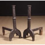 A Pair of Large 16th Century Cast Iron Fire Dogs; the uprights with bearded face mask finials,