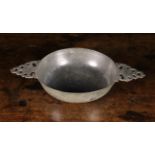 A 17th Century Pewter Porringer with pierced lug handles, 11 ins x 6½ ins (28 cm x 16.5 cms).