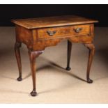 An Early Georgian Walnut Lowboy inlaid with bands of diagonally grained stringing.