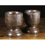 A Pair of Turned Treen Mortars, 8¾ ins (22 cms) in height, 6¼ ins (16 cms) in diameter.