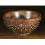 A Turned Elm Bowl adorned with brass studs, probably Scottish, 4½ ins (11 cms) high,