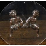 A Charming Early 18th Century Carved Oak Appliqué in the form of two seated cherubs,