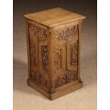 An Oak Pedestal. The near square top above Gothic carved panel sides (one side left open).