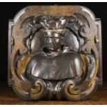 A Baroque Wall Cartouche carved in relief with the bust of a Cardinal in scrolled surround,