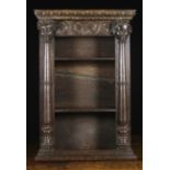 A Small 19th Century Oak Hanging Shelf Unit. The open shelves below a foliate carved frieze.