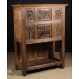 A French Carved Oak Gothic Style Dressoir having two cupboards set one above another flanked by