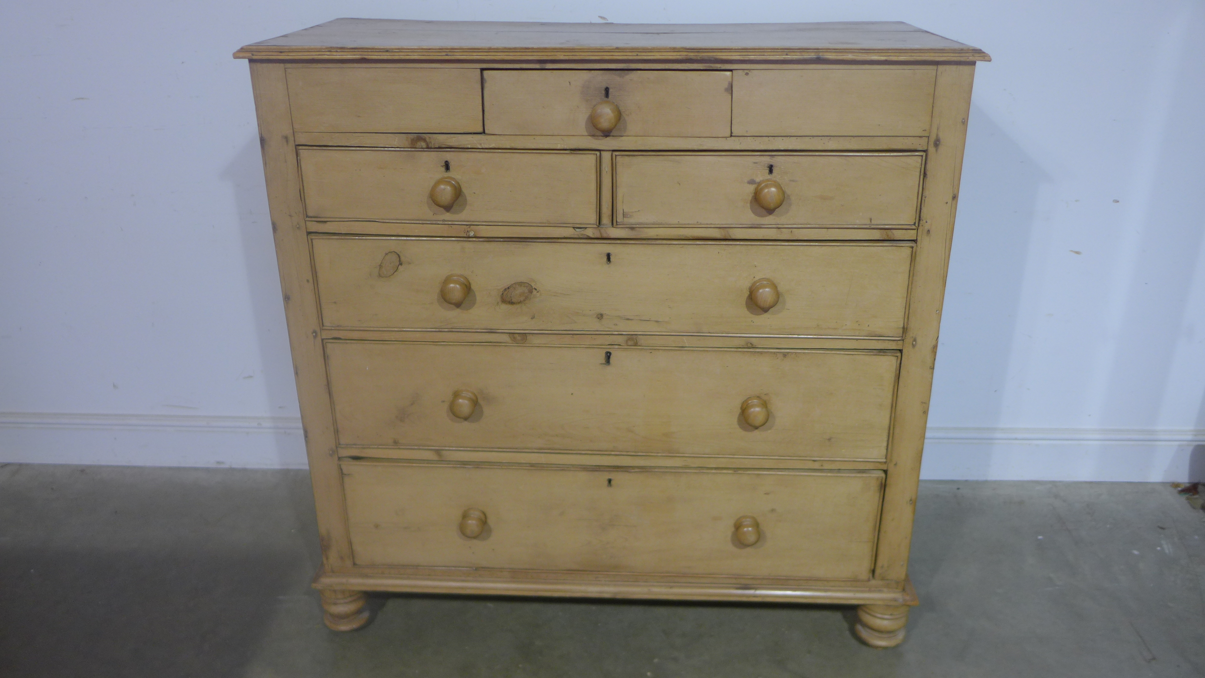 A 19th century pine chest with three small above three long drawers