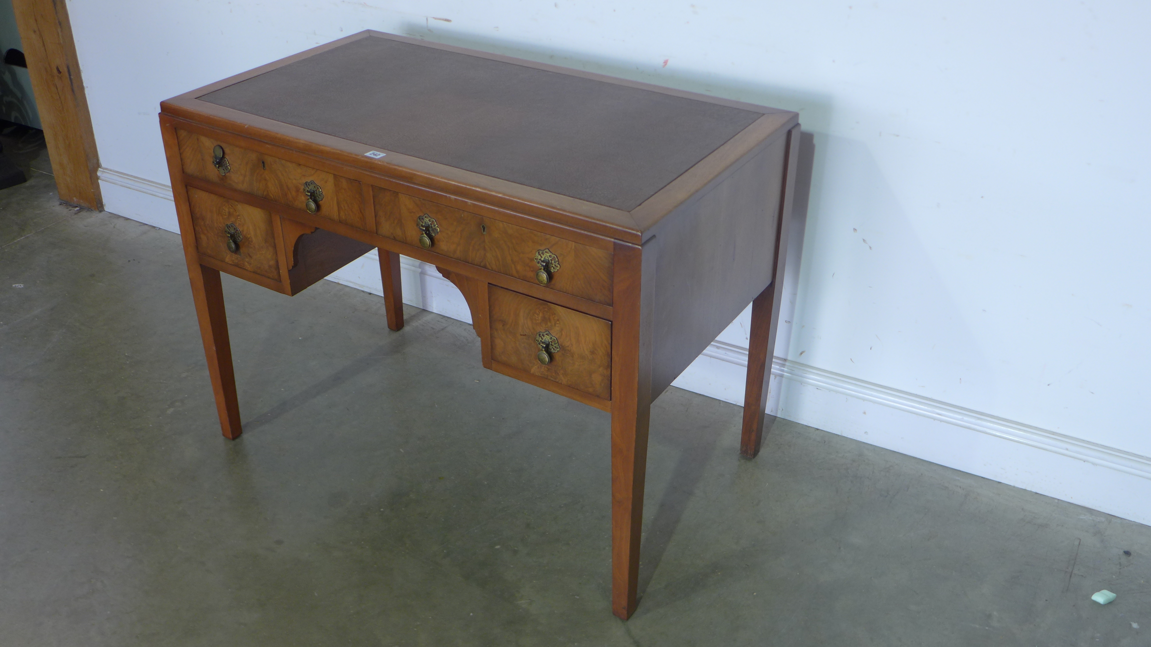 A 1930's walnut desk with five drawers - 79cm x 106cm x 60cm
