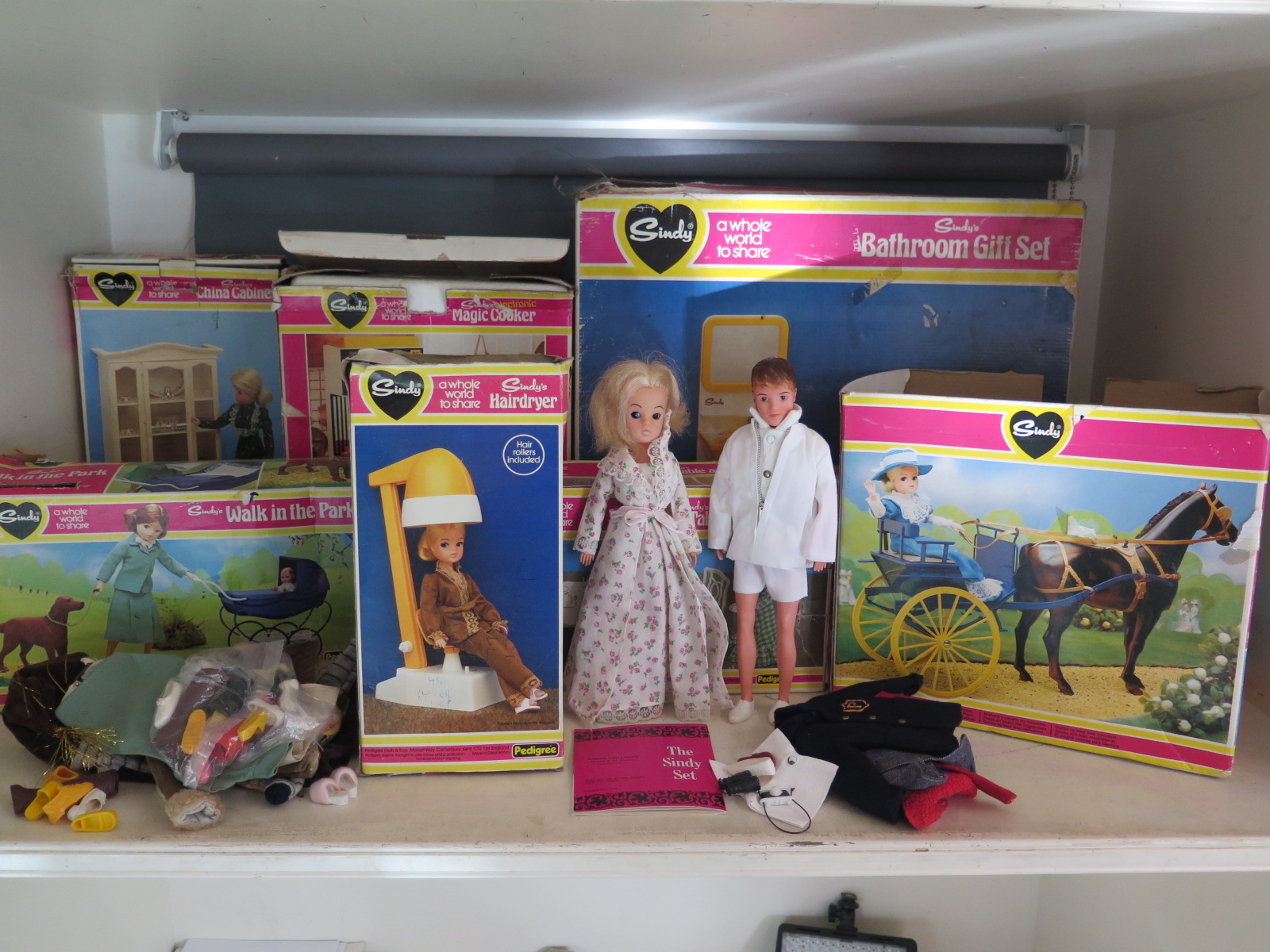 A Sindy collection - comprising a gig and harness, hairdryer, dining table and chairs,