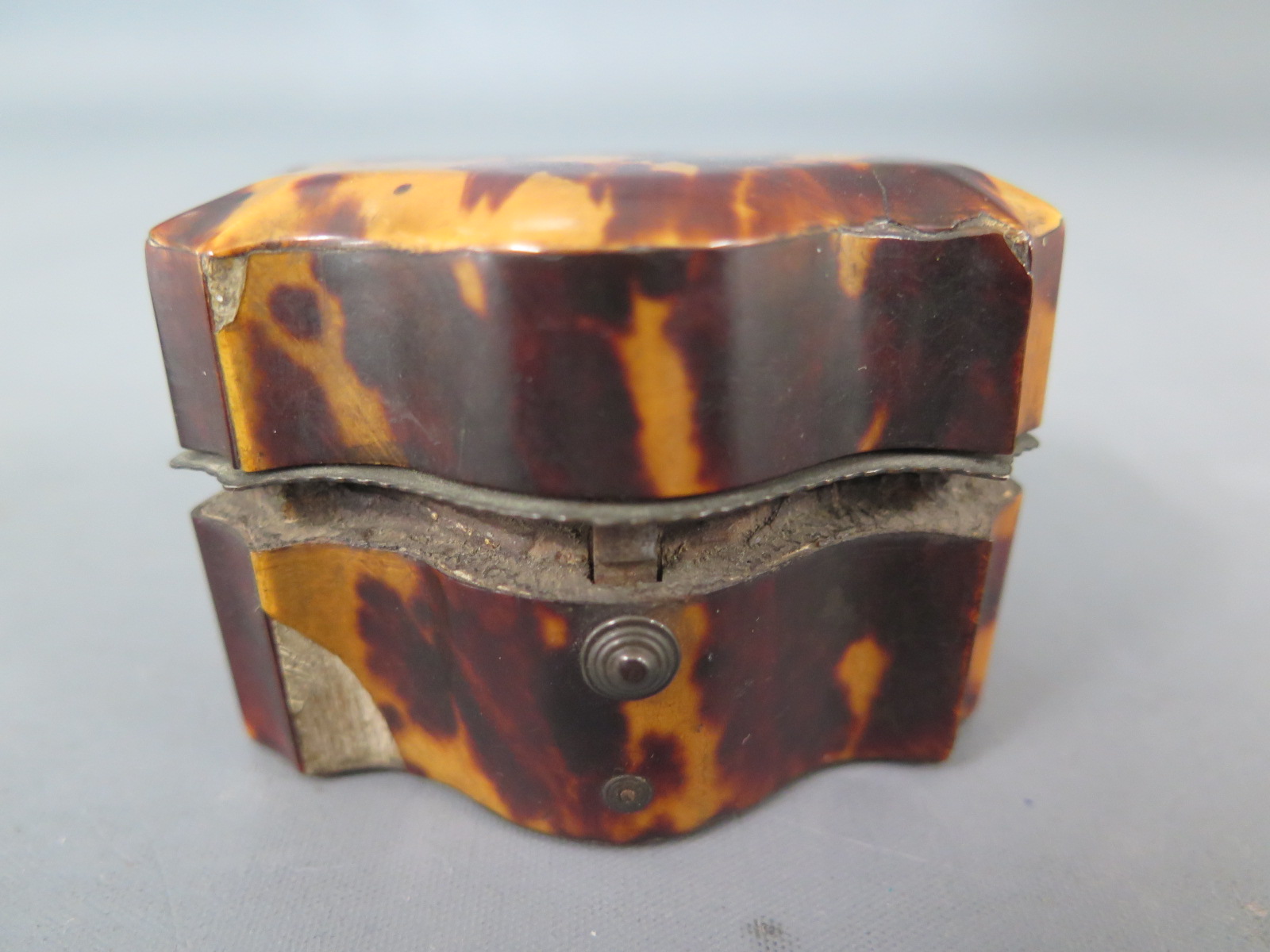 A tortoiseshell miniature desk stand serpentine fronted with fitted interior hinged lid - 6.5cm x 4.