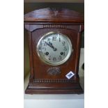 An eight day oak case mantel clock strikes hours and half hour on gong Condition report: Working