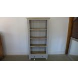 A grey painted open front bookcase of four shelves over two drawers - 90cm x 35cm x 181cm