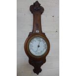 An oak aneroid barometer - Height 90cm Condition report: Missing its thermometer