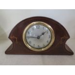 A small mahogany and inlaid cased mantle clock,