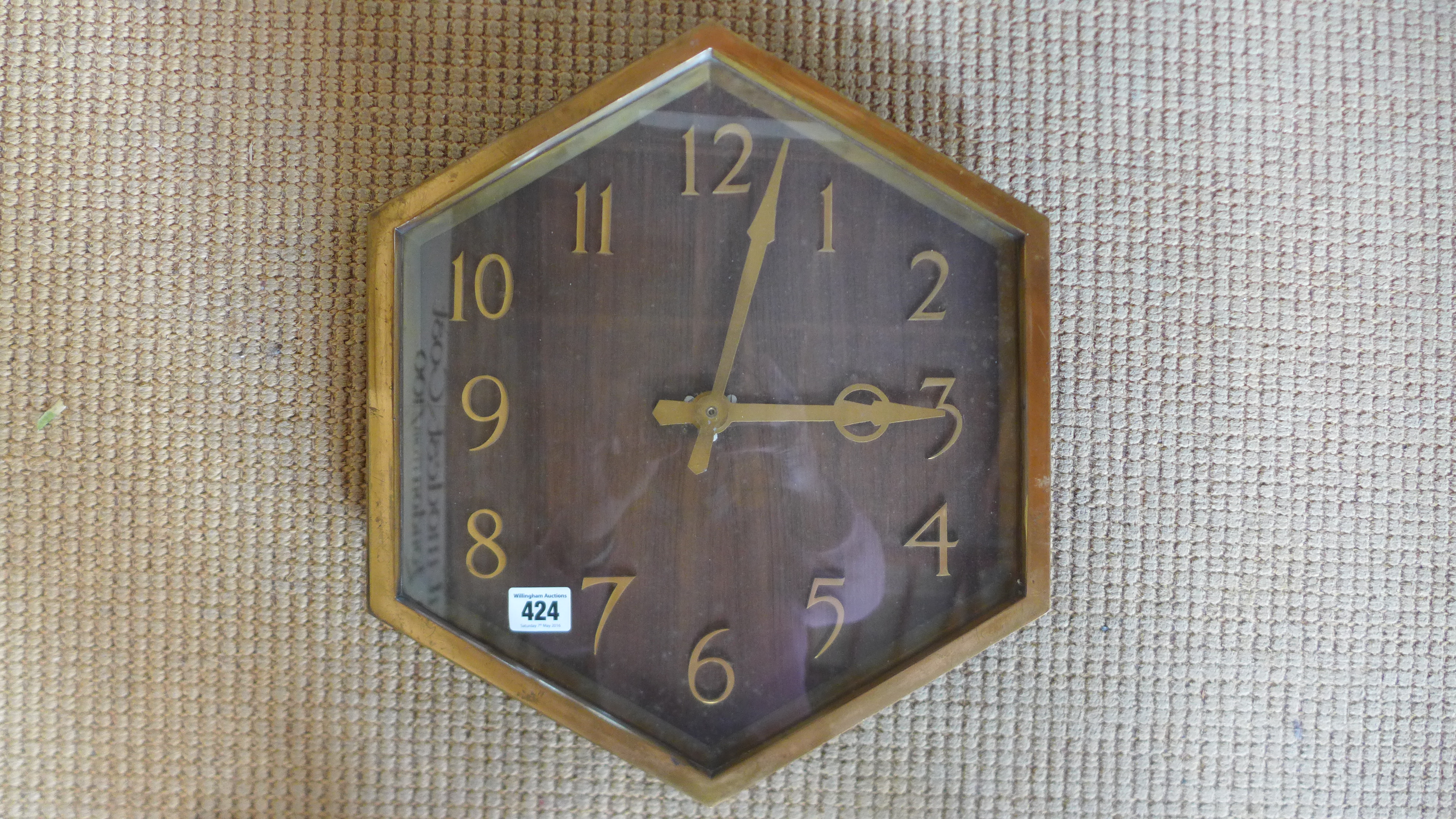 A brass hexagonal dial slave wall clock with a wooden dial - 42cm x 36cm