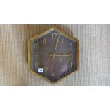 A brass hexagonal dial slave wall clock with a wooden dial - 42cm x 36cm