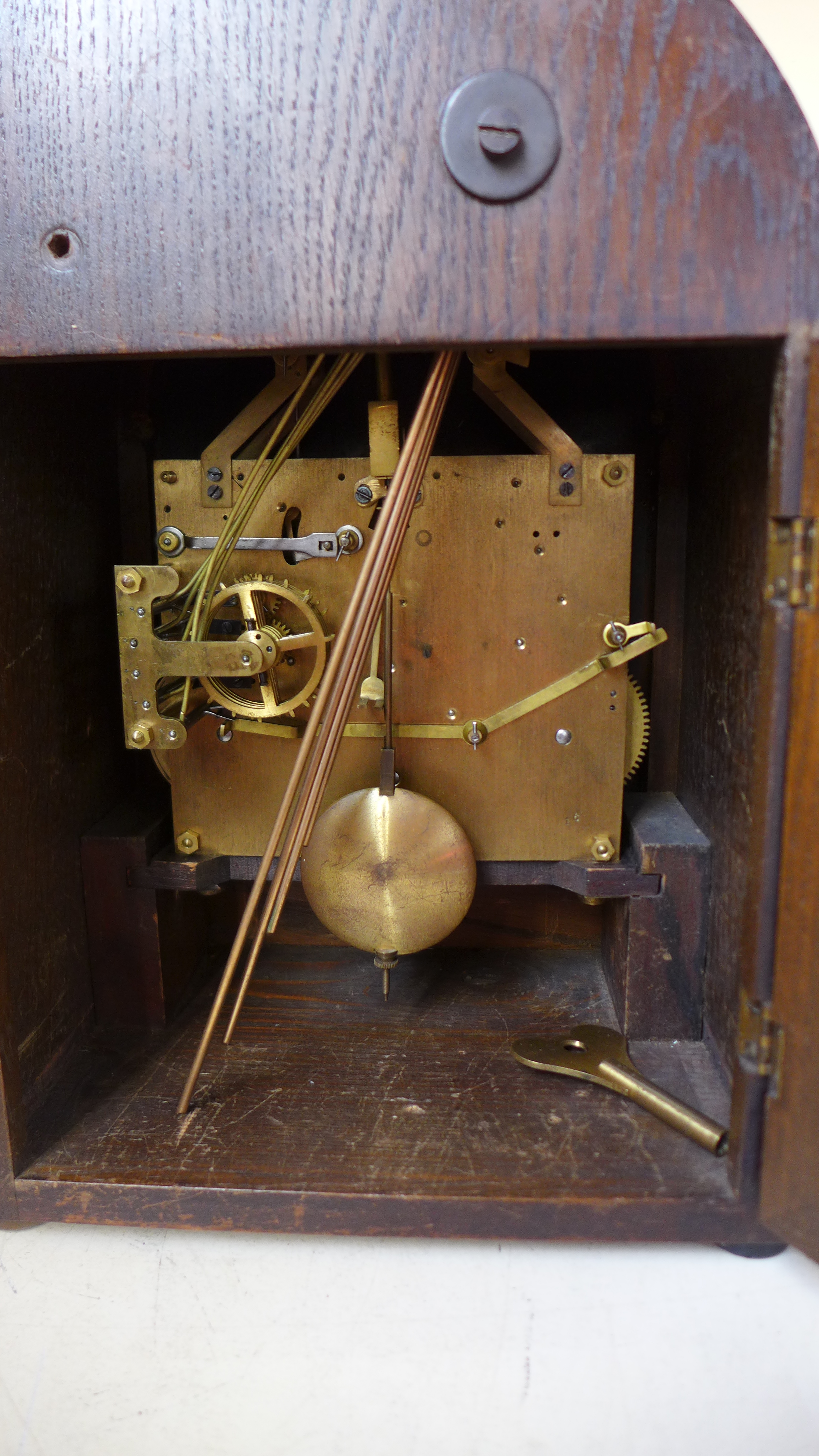 An oak cased German chiming mantle clock with a silvered dial with a pendulum and key - Height 34cm - Image 2 of 2