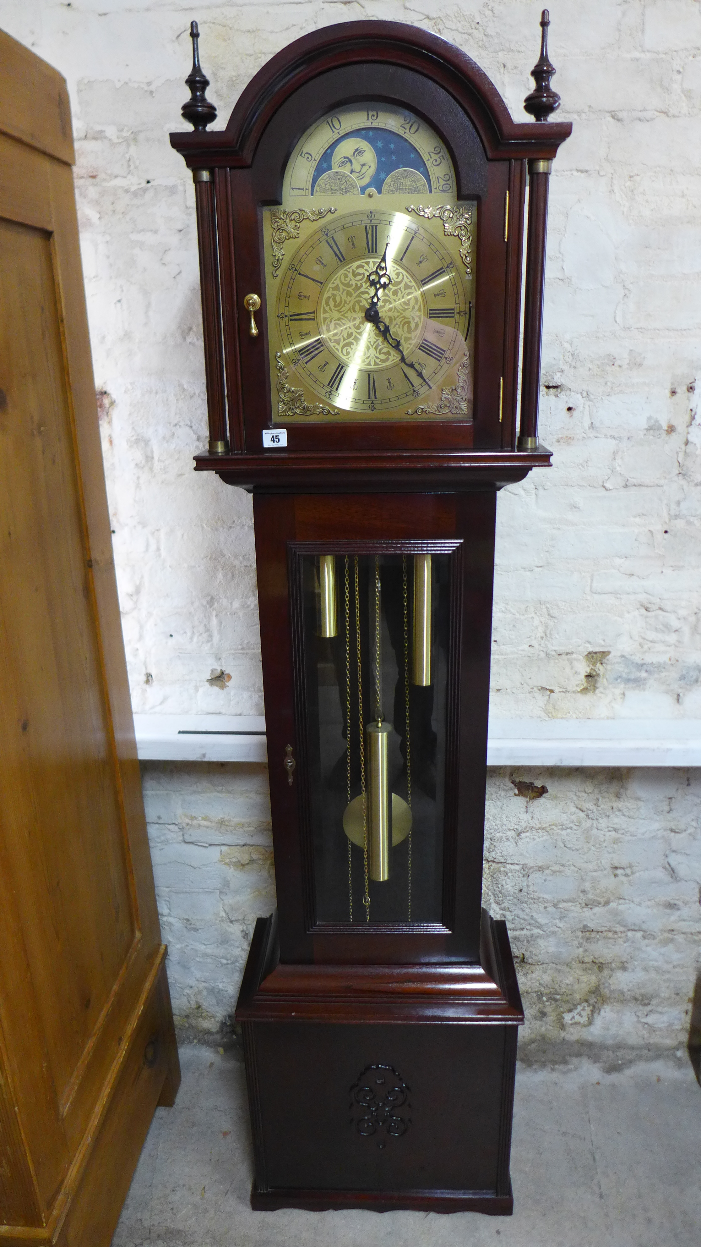 A modern mahogany longcase clock with a three train movement - working in the sale room