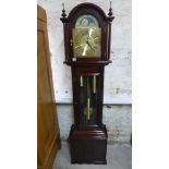 A modern mahogany longcase clock with a three train movement - working in the sale room