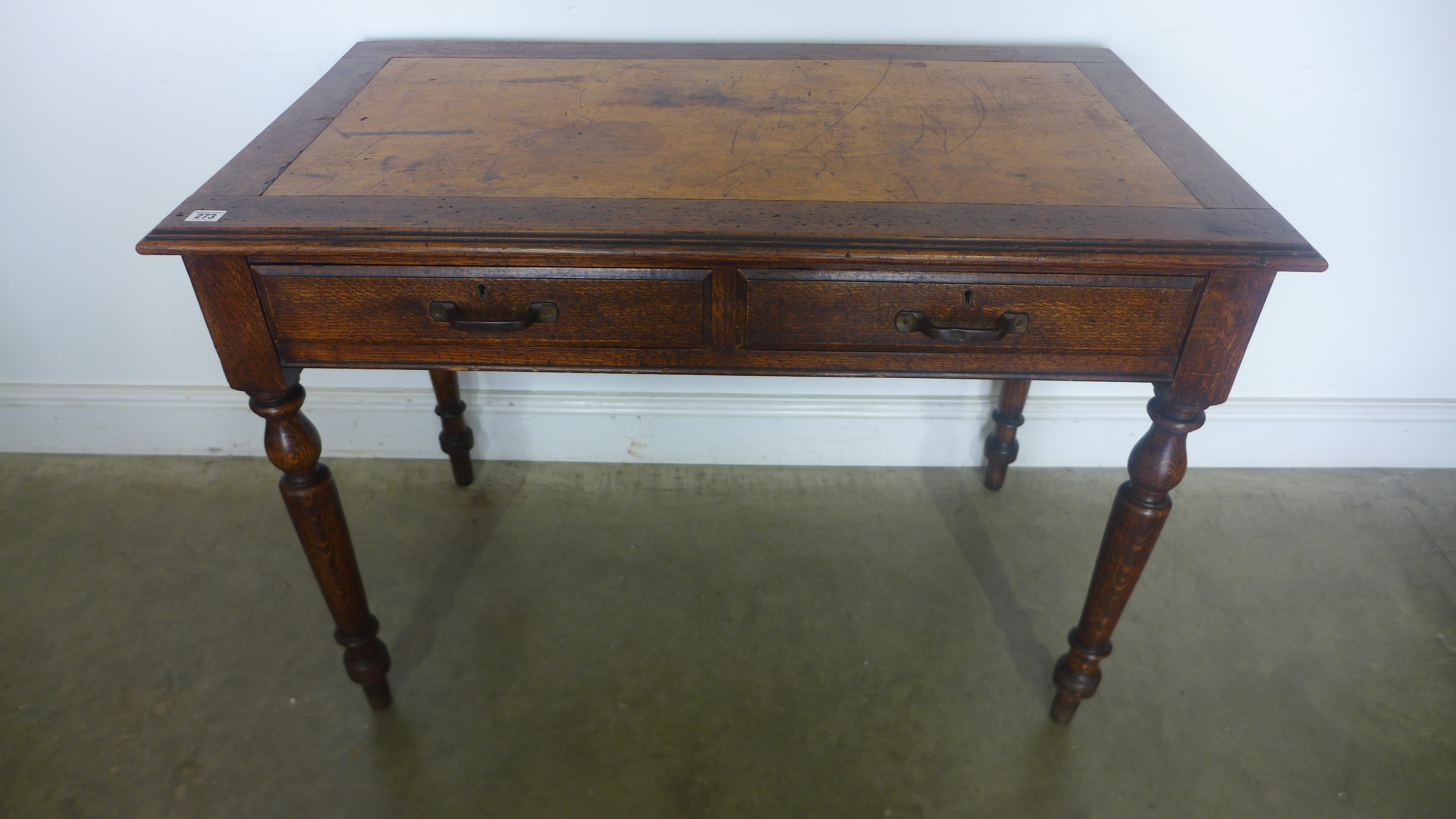 An early 20th century writing desk with two drawers - Width 107cm