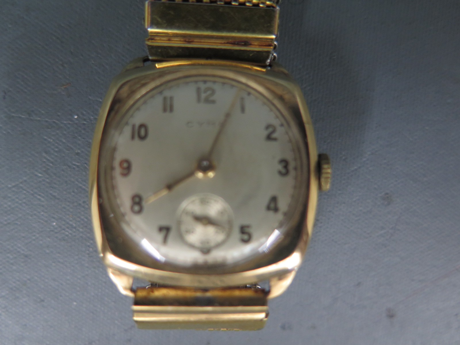 A 9ct yellow gold cased Cyma wristwatch with champagne coloured dial with Arabic numerals, - Image 2 of 2