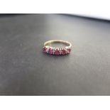 A 9ct gold ruby and diamond half-circle ring - Hallmarked London - Ring size K 1/2 - Weight approx