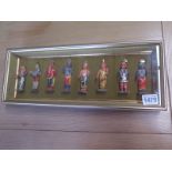 A gilt framed collection of eight Indian plaster wood deities 16cm x 41cm - all appear good