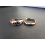 A 9ct gold band ring - Hallmarked London - Ring size O - Together with a 9ct gold sapphire